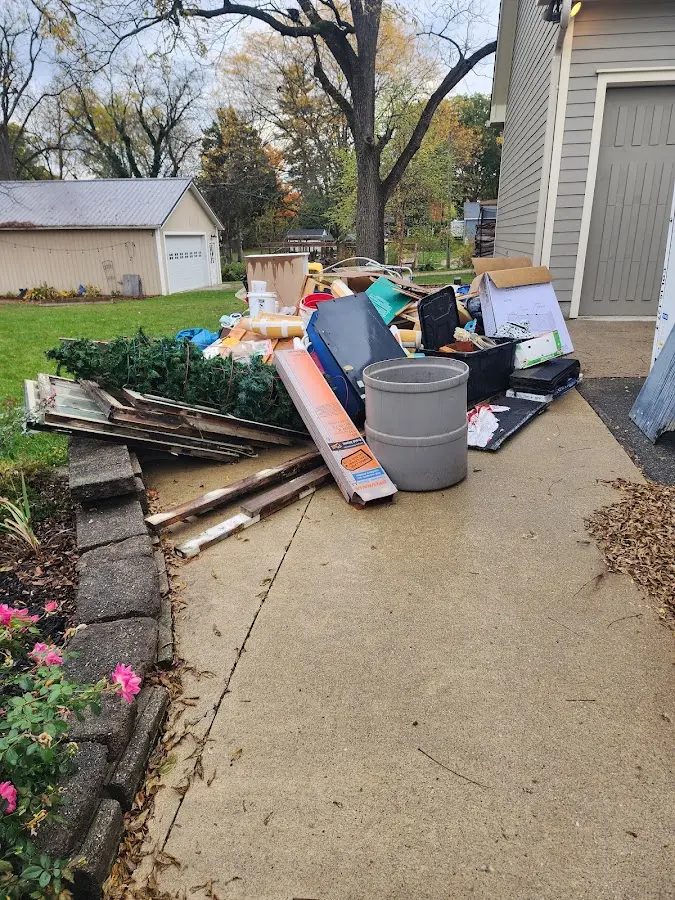 Dumpster being loaded with debris for Residential Dumpster Rental in Linden